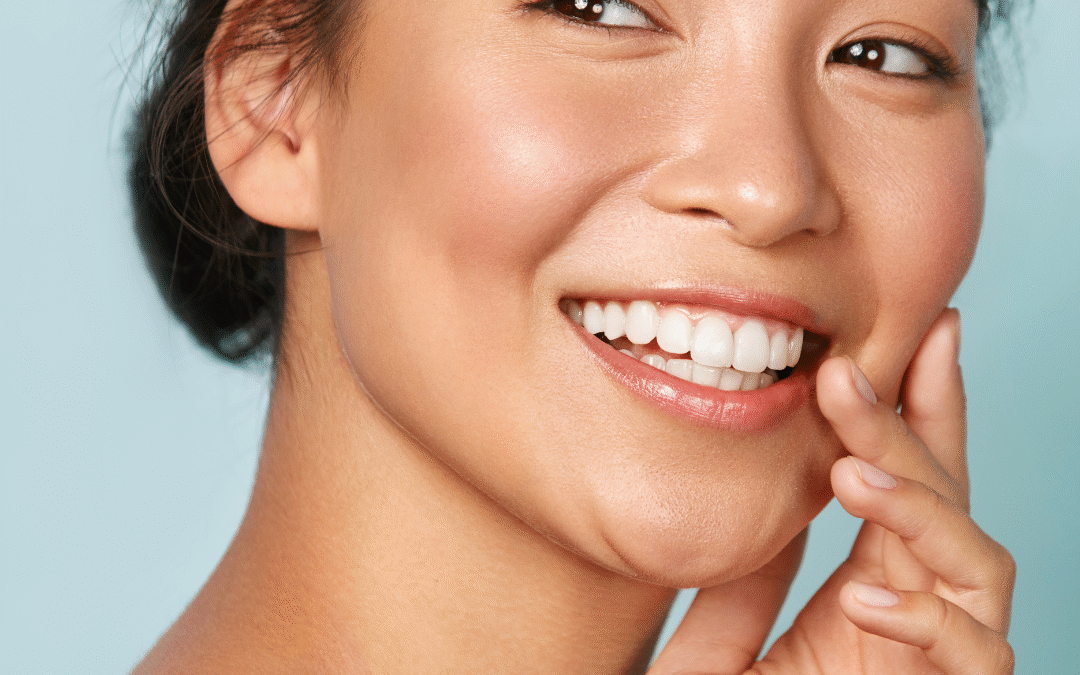 Young woman smiling with fresh, glowing skin after a professional facial treatment at Bedford Skincare Clinic